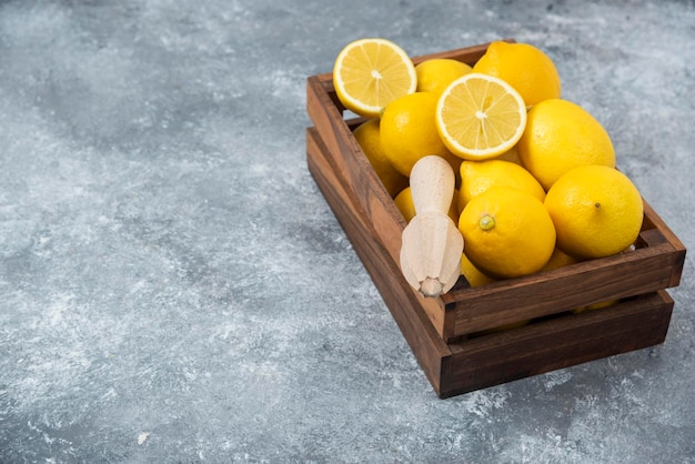 Lemons in wood box sliced and full freshly composition grey backround