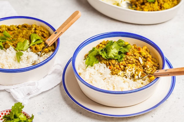 Lentil curry with rice, Indian cuisine, tarka dal, white background. Vegan food. 