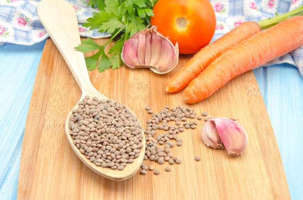 Lentils and vegetables on a wooden board