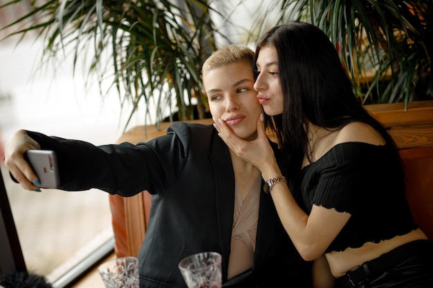 Lesbian couple on a date in a restaurant drinking wine