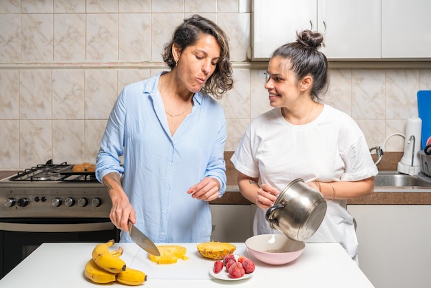 Lesbian couple preparing food together in the kitchen