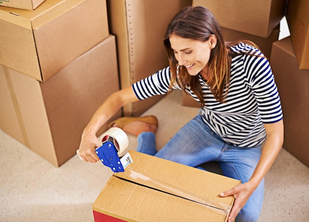 Lets get moving Shot of an attractive young woman busy moving house