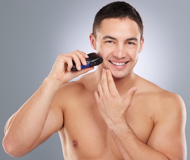 Lets take off a few years. Shot of a handsome young man shaving his facial hair.