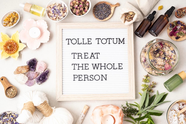 Letter board with text Tolle totum meaning treat the whole person in latin Naturopatical principle