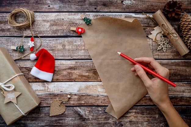 Letter to santa claus, christmas wishlist on wooden background