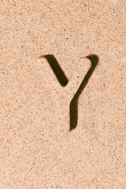 Letter Y of the sand isolated on the beach sand concept of summer alphabet