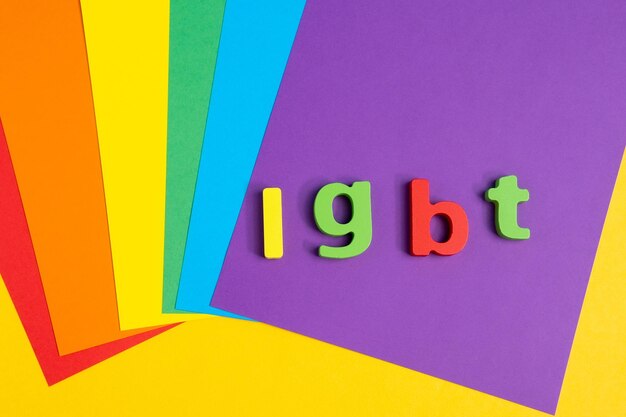 Photo lettering lgbt on a colorful rainbow background top view