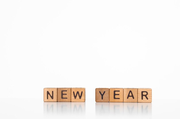 letters of the alphabet of New Year 2023 on wooden cubes white background