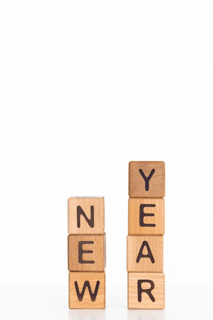 Photo letters of the alphabet of new year 2023 on wooden cubes white background