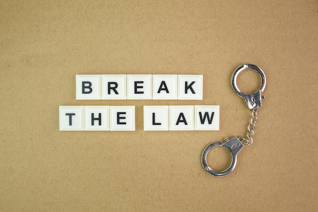 letters of the alphabet with the word break the law. the concept of not complying with the law