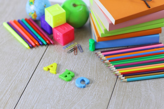 Letters and school supplies on wooden background.photo with copy space.