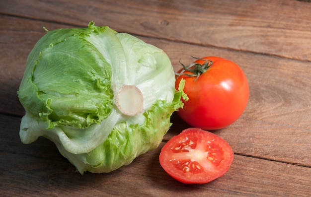 Lettuce and Tomato on a wooden background