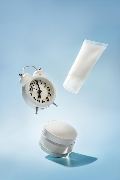 Levitating cosmetics and watches on a blue background