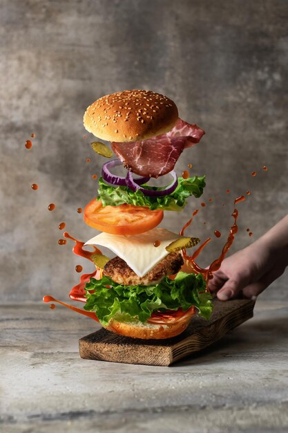 Levitation food concept Delicious burger with flying ingredients