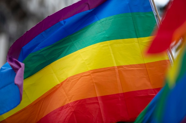 A lgbt gay pride rainbow flag being waved at a pride community celebration event