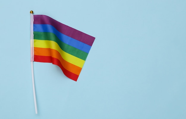 LGBT rainbow flag on blue background. Tolerance, freedom, gay parade