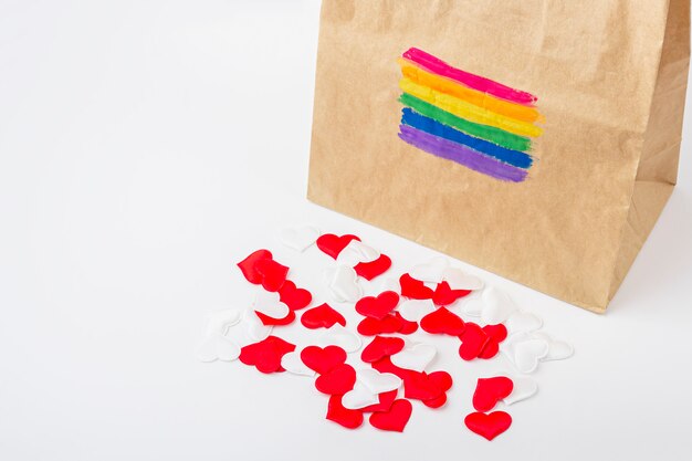 LGBT rainbow flag painted on a paper gift bag and fabric hearts