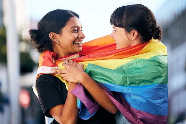 Lgbtq happy women and flag for pride equality and protest of love support and care in city Gay lesbian and couple of friends with rainbow identity gen z festival and human rights freedom event