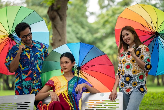 LGBTQ LGBT Gays Celebration Concept Portraits Gay Friend holding Rainbow Umbrella at Park symbol