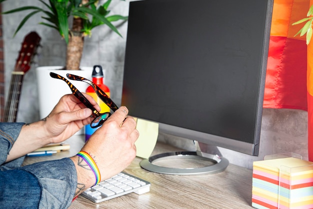 LGBTQIA culture Man working in office with LGBT accessories