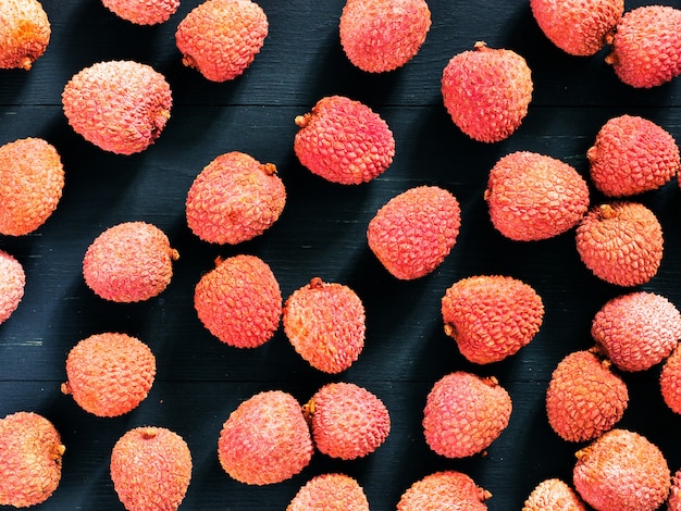 Lichee fruit on dark wooden surface