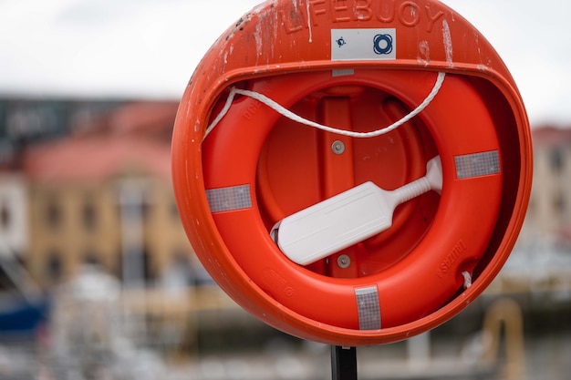 Life buoy and lifebelt on the wharf in a city Red lifebuoy