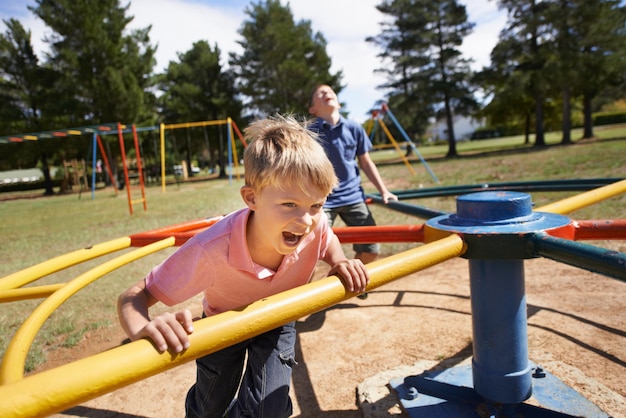 Life is a playground when youre young A group of young boys sitting on a playground