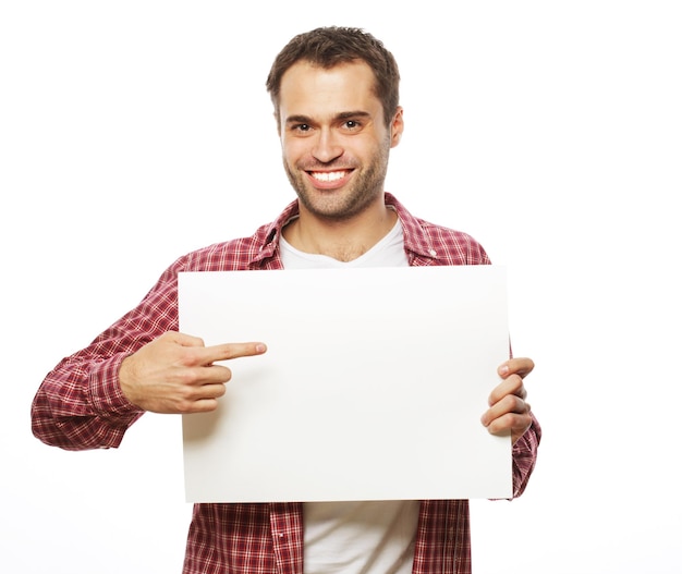 Life style  and people concept:young handsome man showing blank signboard, isolated over white background