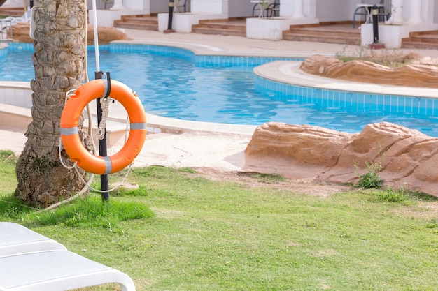 Lifebuoy on the fence, by the pool on vacation at the hotel