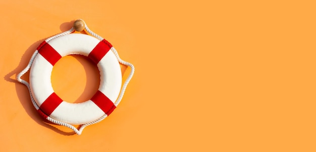 Lifebuoy on orange background Copy space