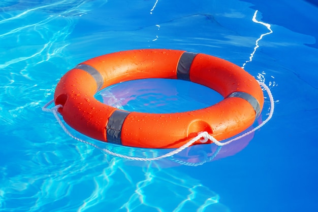 Lifebuoy pool ring float. Life ring in swimming pool.