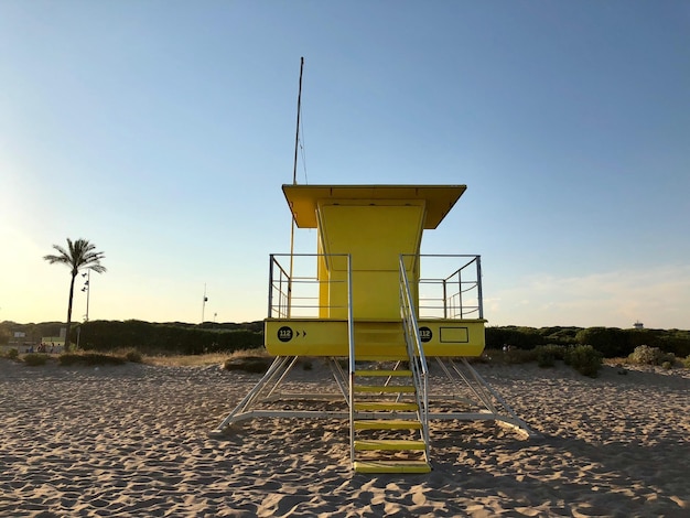 Photo lifeguard hut on beach against clear sky