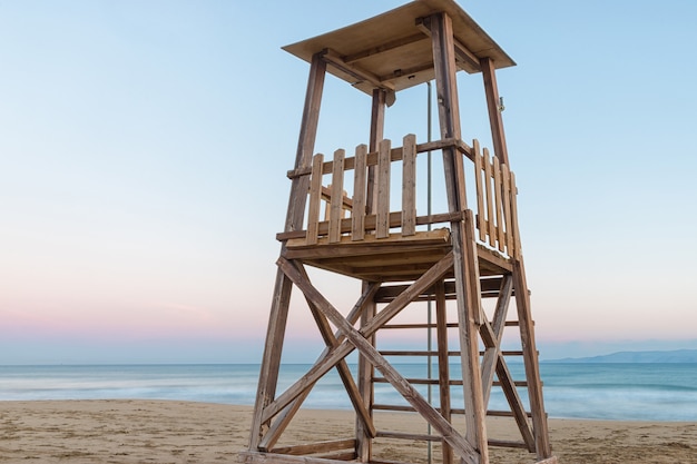 A lifeguard tower on the mediterranean beach at sunset during the summer