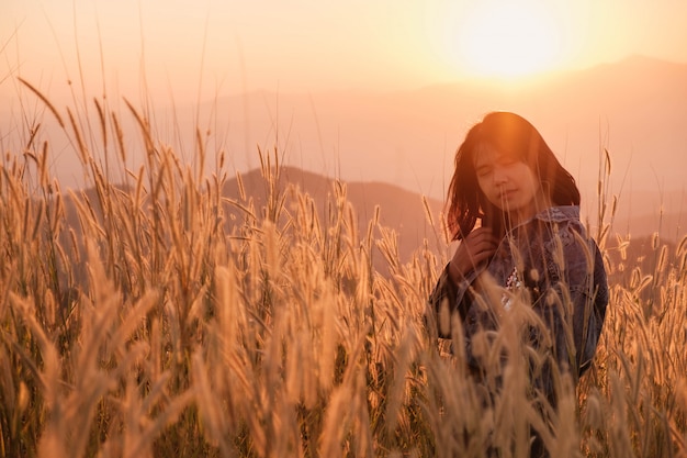 Lifestyle Beautiful  women in the meadow and the sunset light