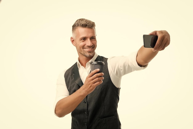 Lifestyle blogger on coffee break Handsome well groomed man taking selfie photo for personal blog Online blog Digital influencer concept Video call communication Personal blog social networks