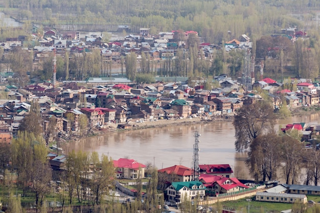  Lifestyle in Dal lake, man drive the boat in middle of the Dal lake and mountain backgrou