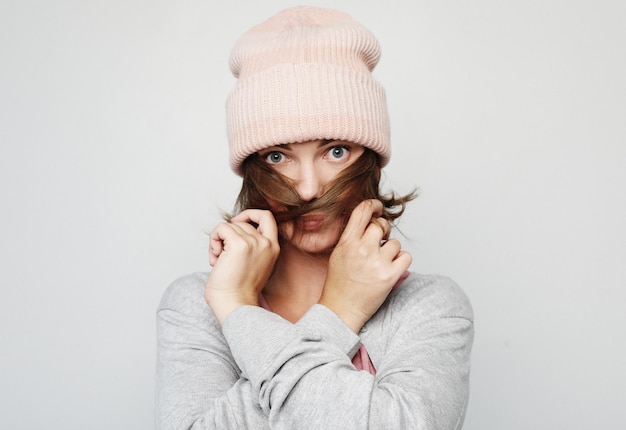 Lifestyle emotion and people concept young emotional woman wearing pink hat