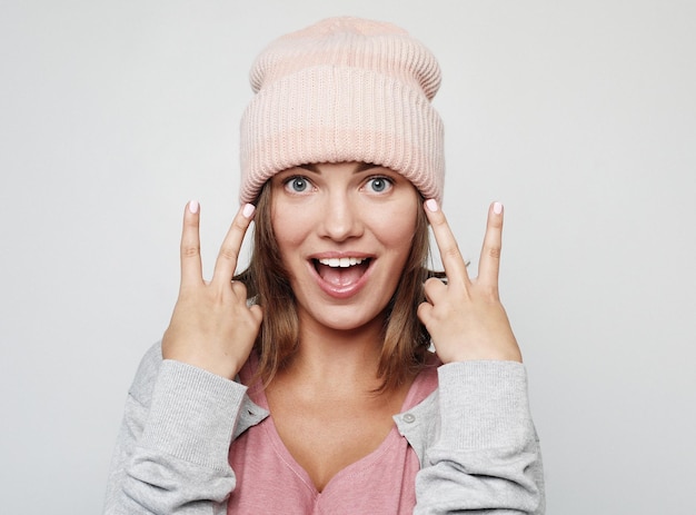 Lifestyle emotion and people concept young woman dressed casually making faces at camera