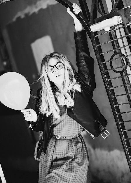 Lifestyle fashion and people concept blonde girl in the summer city black and white picture