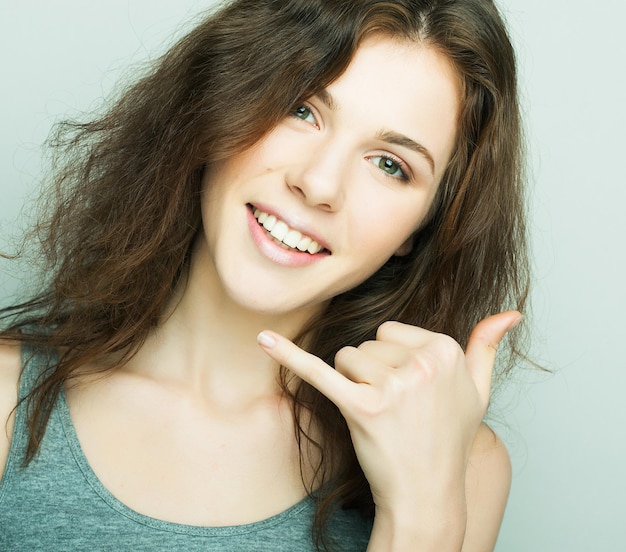 Lifestyle fashion and people concept young curly woman posing in studio