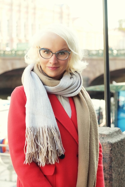 lifestyle fashion portrait of young stylish woman walking on the street wearing cute trendy outfit