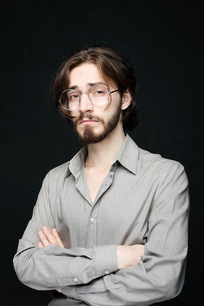 Lifestyle and people concept Portrait of handsome young bearded man on dark background