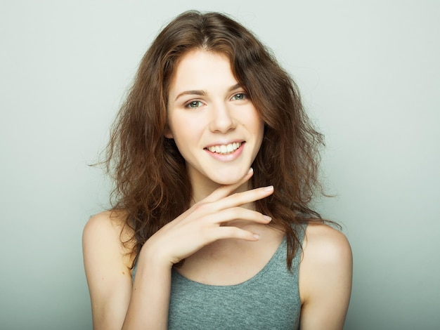 Lifestyle and people concept Young cute smiling curly girl studio shoot