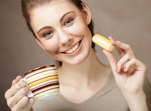 Lifestyle people and food concept young woman with coffee and cookies