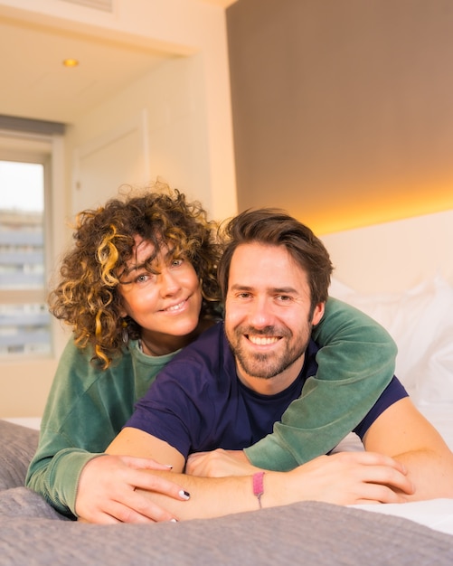 Lifestyle, portrait of a young Caucasian couple in pajamas on the bed