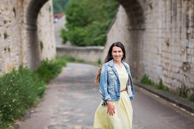 Lifestyle portrait of young stylish woman with long brunette hair