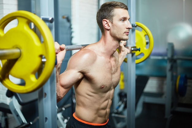 Lifting Barbell at Gym