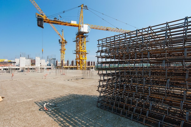 lifting construction crane and metal structures at the construction site