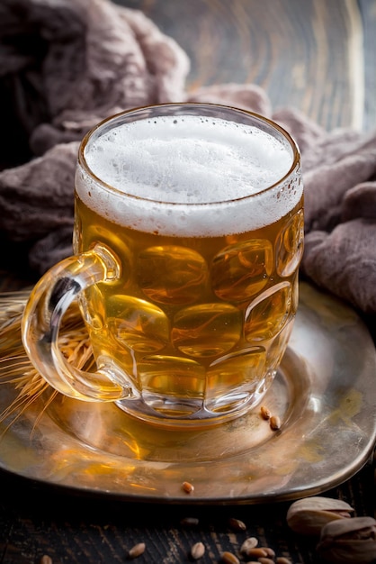 Light beer in a glass on an old background