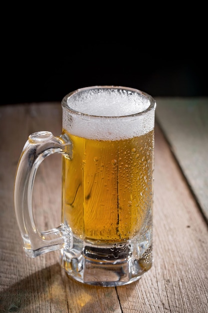 Light beer in a glass on an old background